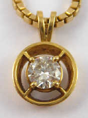 Appraisal: A yellow metal tests carat gold diamond solitaire pendant on