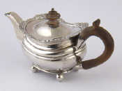 Appraisal: A barge shaped low grade silver bachelor's teapot on ball