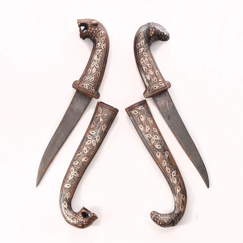 Appraisal: PAIR SOUTHEAST ASIAN KHANJAR DAGGERS Animal design metal scabbards w