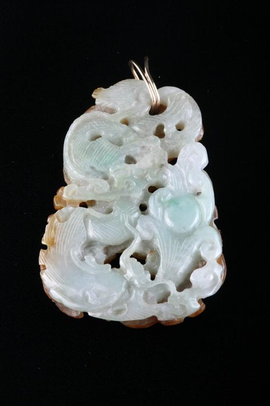 Appraisal: CHINESE TWO-COLOR CARVED JADE PENDANT Carved and pierced with plant