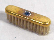 Appraisal: A gold mounted nail brush set with rose cut diamonds