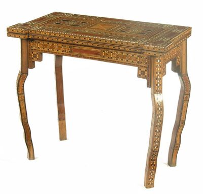 Appraisal: A Syrian walnut and parquetry card table inlaid various woods