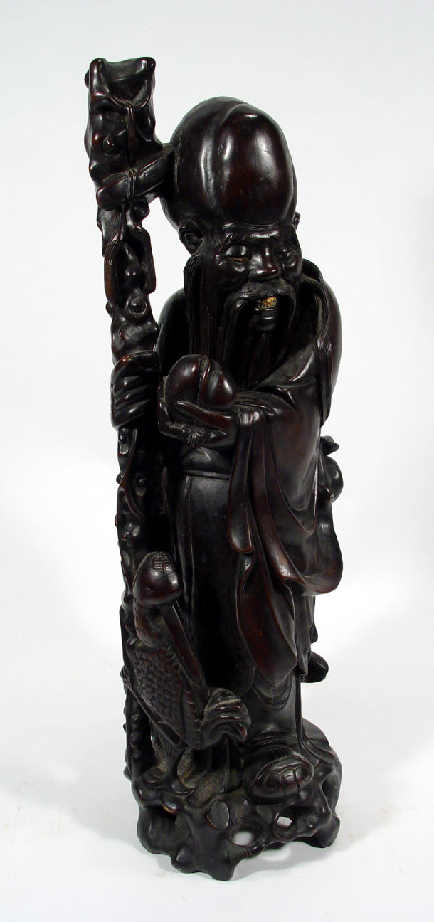 Appraisal: Large oriental carved hardwood figure of an elder clutching a