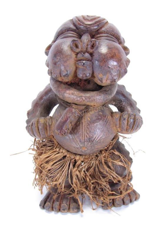 Appraisal: Carved Clay Reliquary c mid th century partial grass skirt