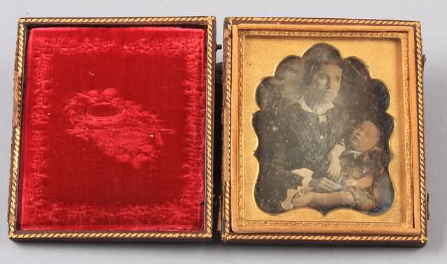 Appraisal: Sixth plate daguerreotype of woman holding dead child Woman wears