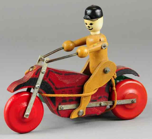 Appraisal: BOY ON MOTORCYCLE WITH SIDE CAR PULL TOY Rich Toys