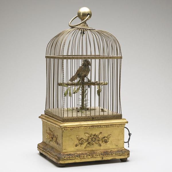 Appraisal: MECHANICAL MUSICAL BIRD In gilded metal cage with key-wind mechanism