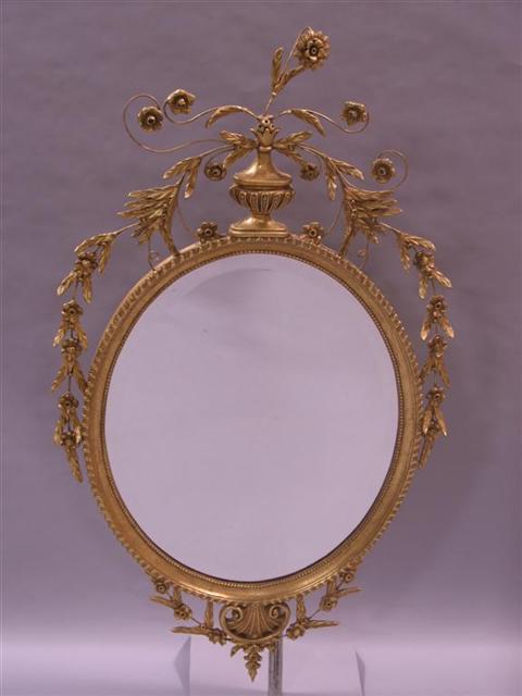 Appraisal: NEOCLASSICAL STYLE GOLD PAINTED MIRROR Twentieth century the oval beveled