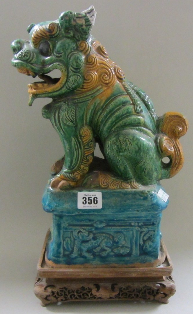 Appraisal: A Ming style pottery model of a buddhistic lion seated