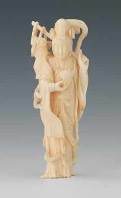 Appraisal: A Carved Ivory Figurine of a Maiden Depicted standing holding