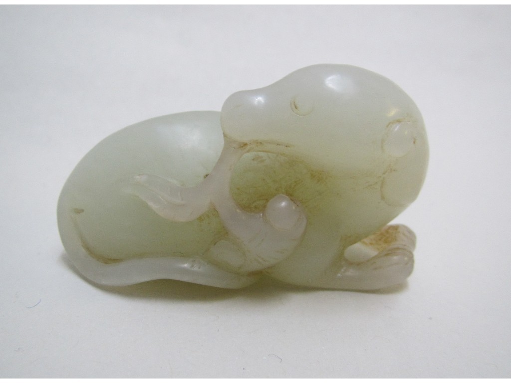 Appraisal: A Chinese pale jade carving of a puppy seated with