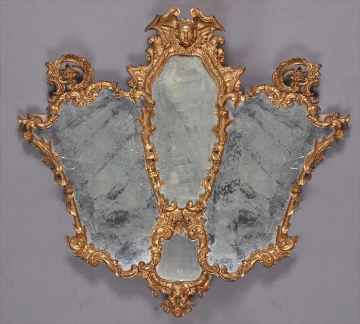 Appraisal: ITALIAN BAROQUE-STYLE CARVED GILTWOOD OVERMANTLE MIRROR The four-part plate within