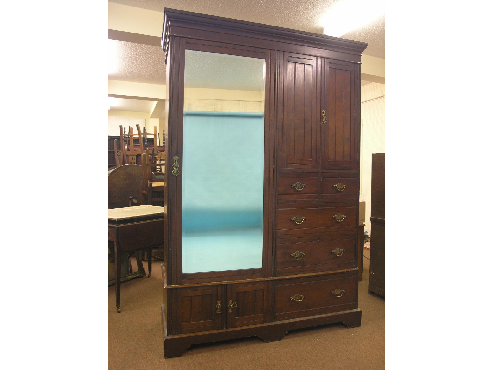 Appraisal: A late Victorian walnut Beaconsfield wardrobe three-quarter-length mirror door alongside