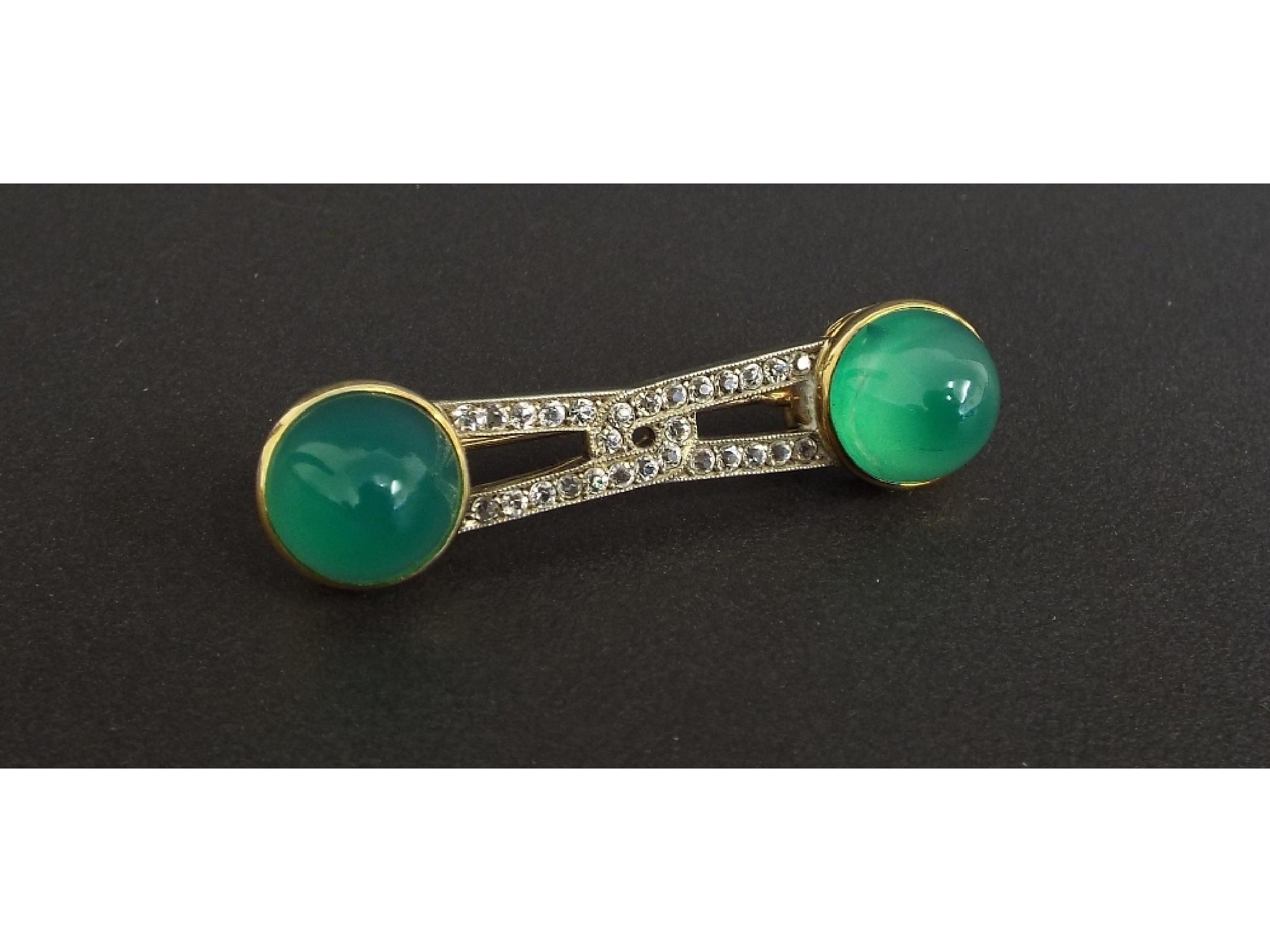 Appraisal: Unusual gold brooch with clear paste and two green coloured