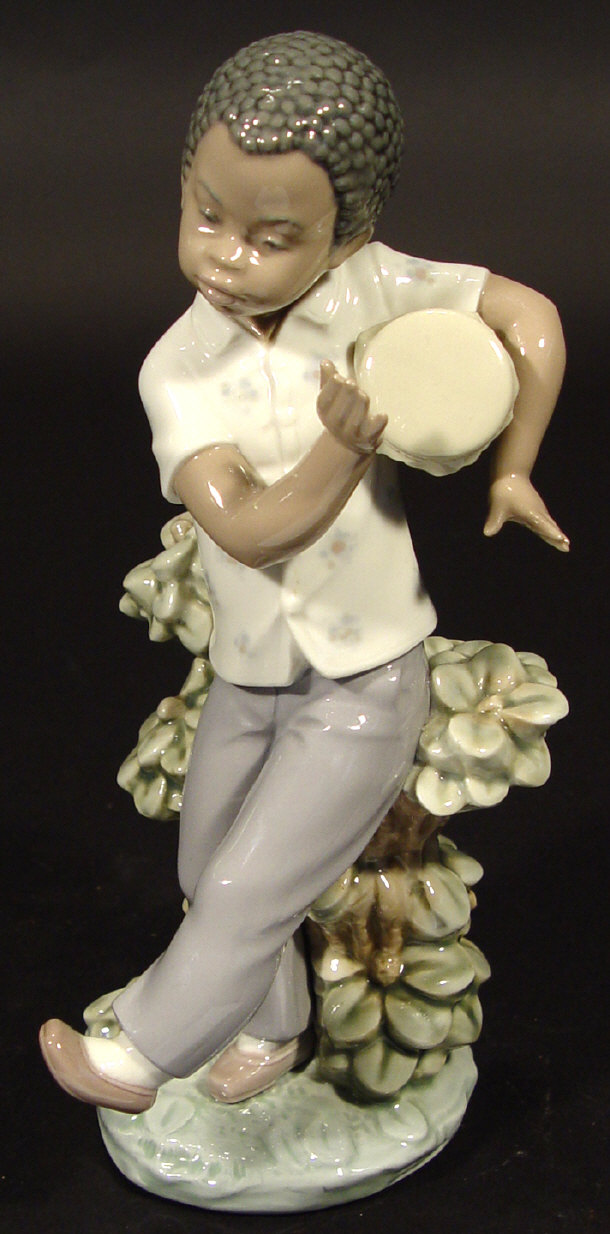 Appraisal: Lladro porcelain figure of a young black boy playing a