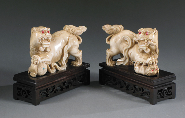 Appraisal: PAIR CHINESE IVORY HAND CARVED IVORY FOO LIONS one holding