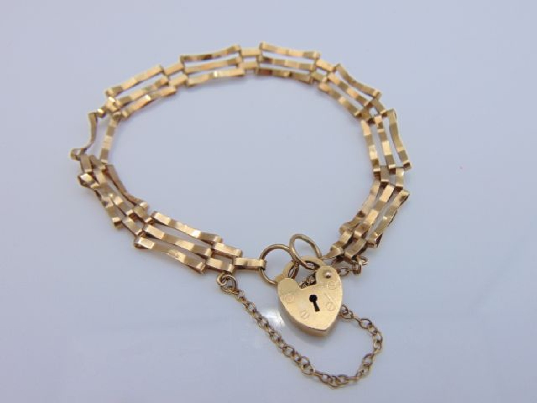 Appraisal: A ct gold gate-link bracelet with heart-shaped padlock clasp g