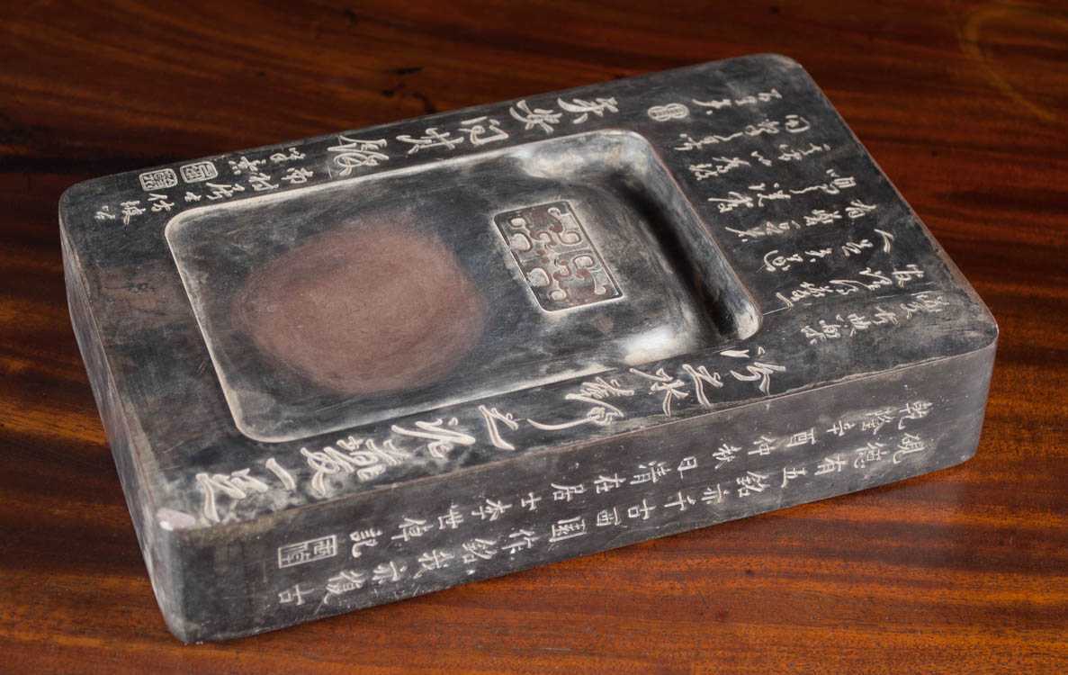 Appraisal: CHINESE INKSTONE of rectangular form and carved with poetic inscription