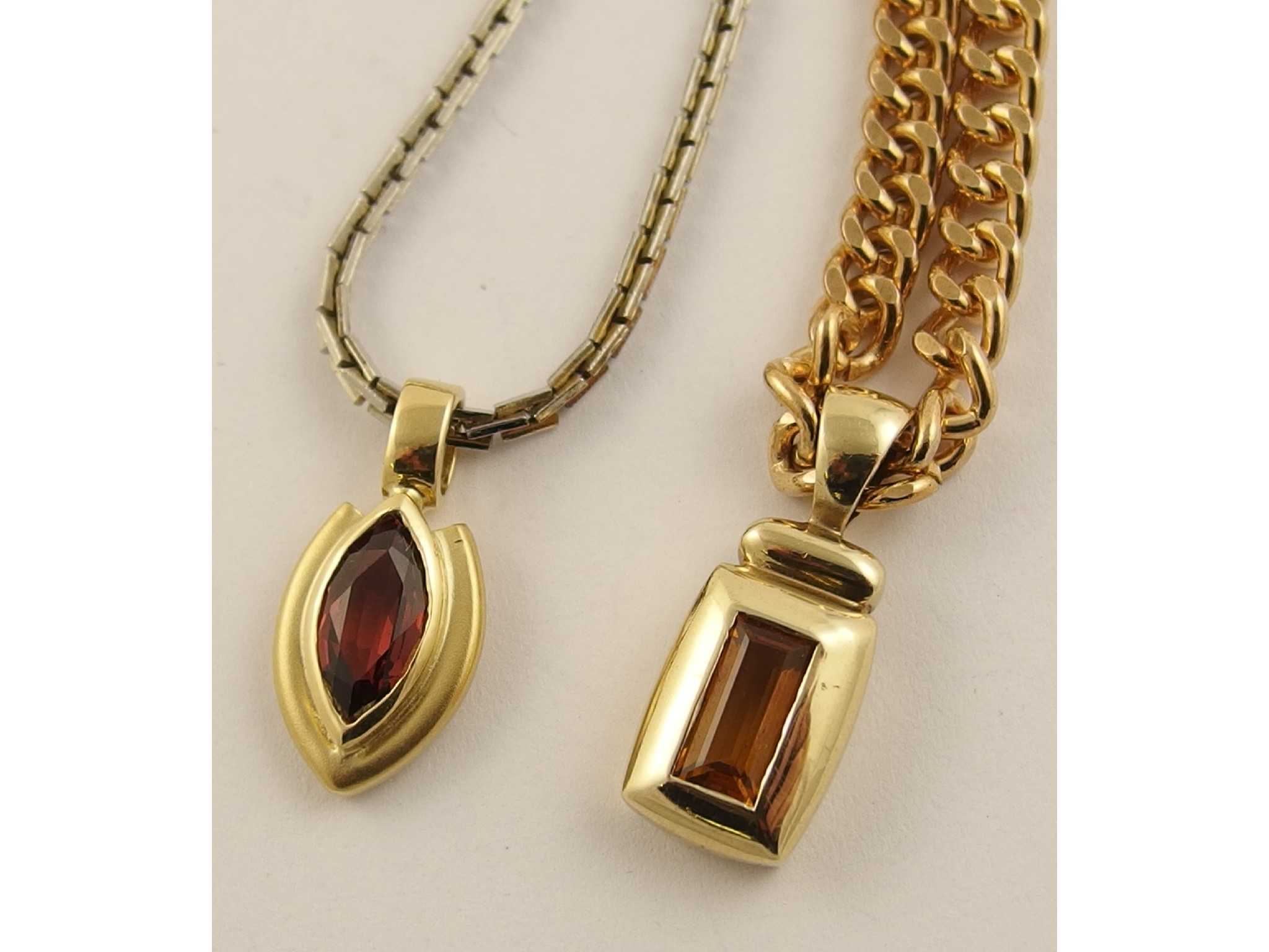 Appraisal: An ct marquis shaped garnet pendant and a ct oblong