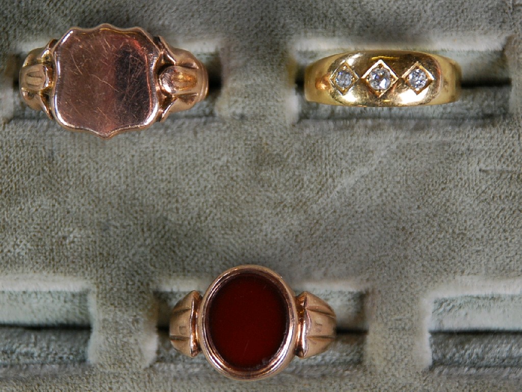 Appraisal: SMALL GOLD RING INSET WITH THREE SMALL DIAMONDS within diamond