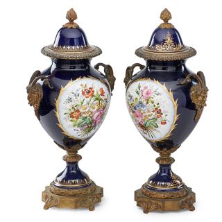 Appraisal: PAIR OF SEVRES STYLE PORCELAIN URNS Gilt bronze mounted and