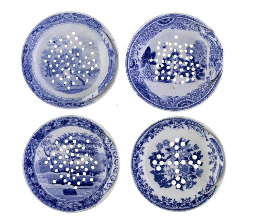 Appraisal: FOUR SPODE BLUE PRINTED EARTHENWARE EGG DRAINERS Castle Temple Tower