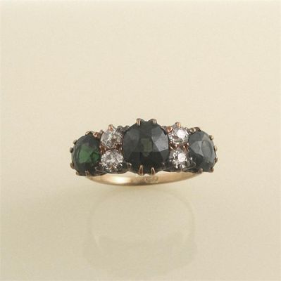 Appraisal: A green sapphire and diamond set seven stone ring The