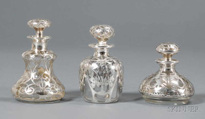 Appraisal: Three Silver Overlay Colognes Clear glass and silver Early th