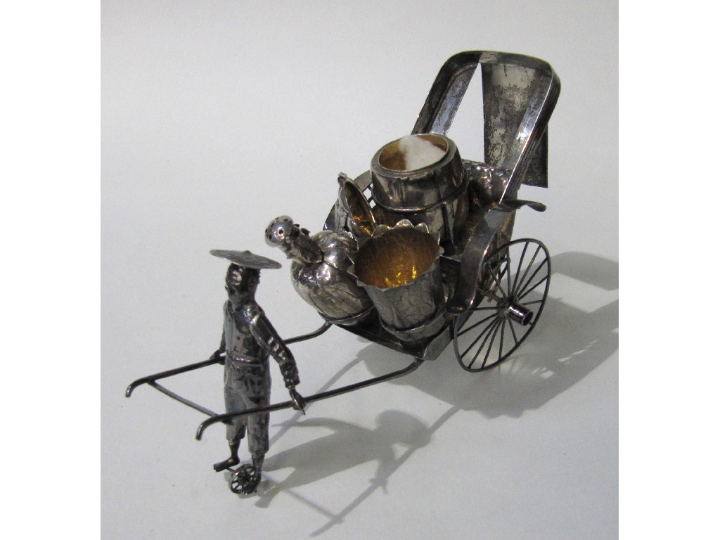 Appraisal: Oriental white metal condiment stand modelled as a rickshaw with