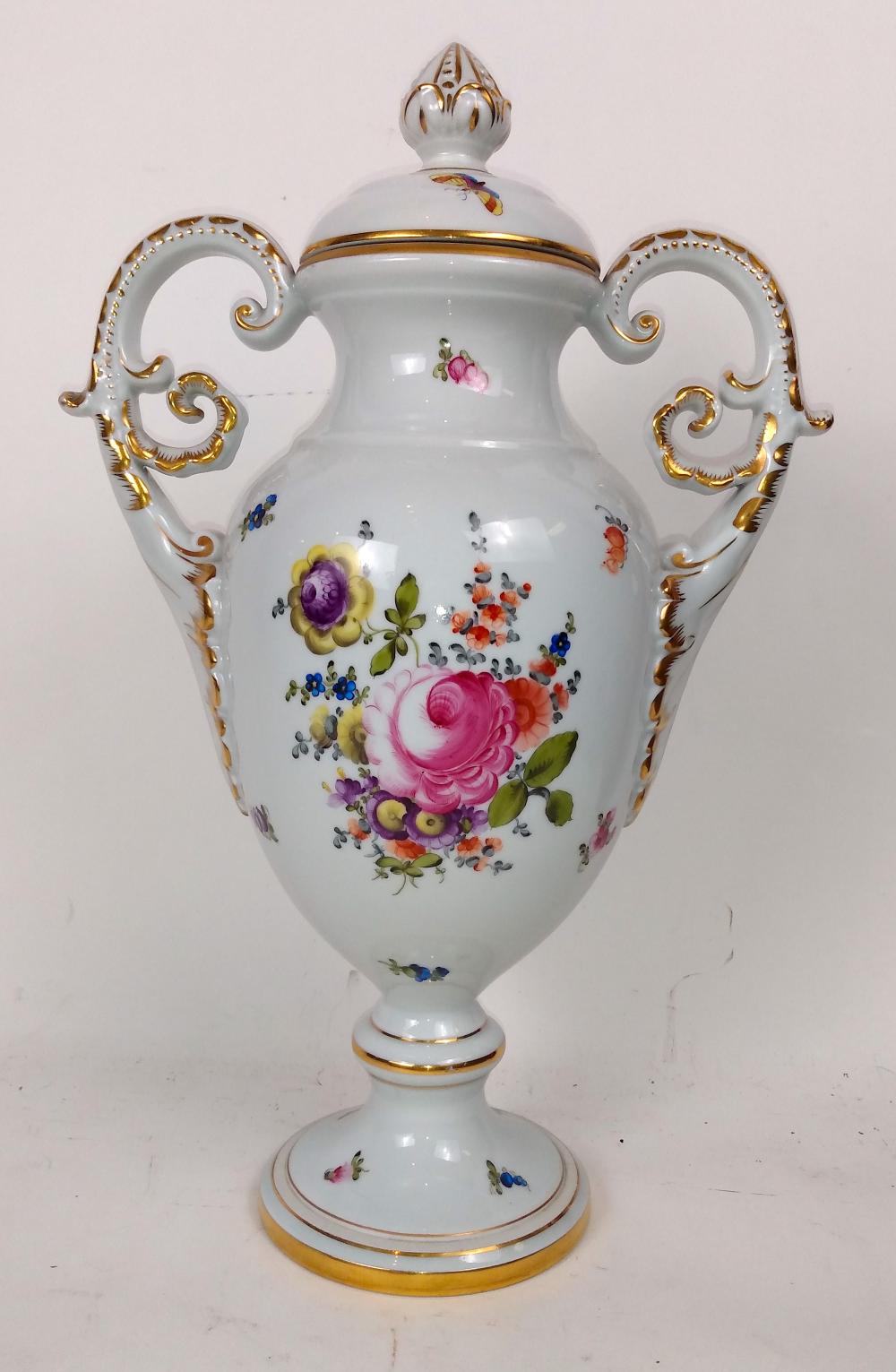 Appraisal: HEREND FOLIATE DECORATED PORCELAIN TWO-HANDLED LIDDED URNThe underside with blue