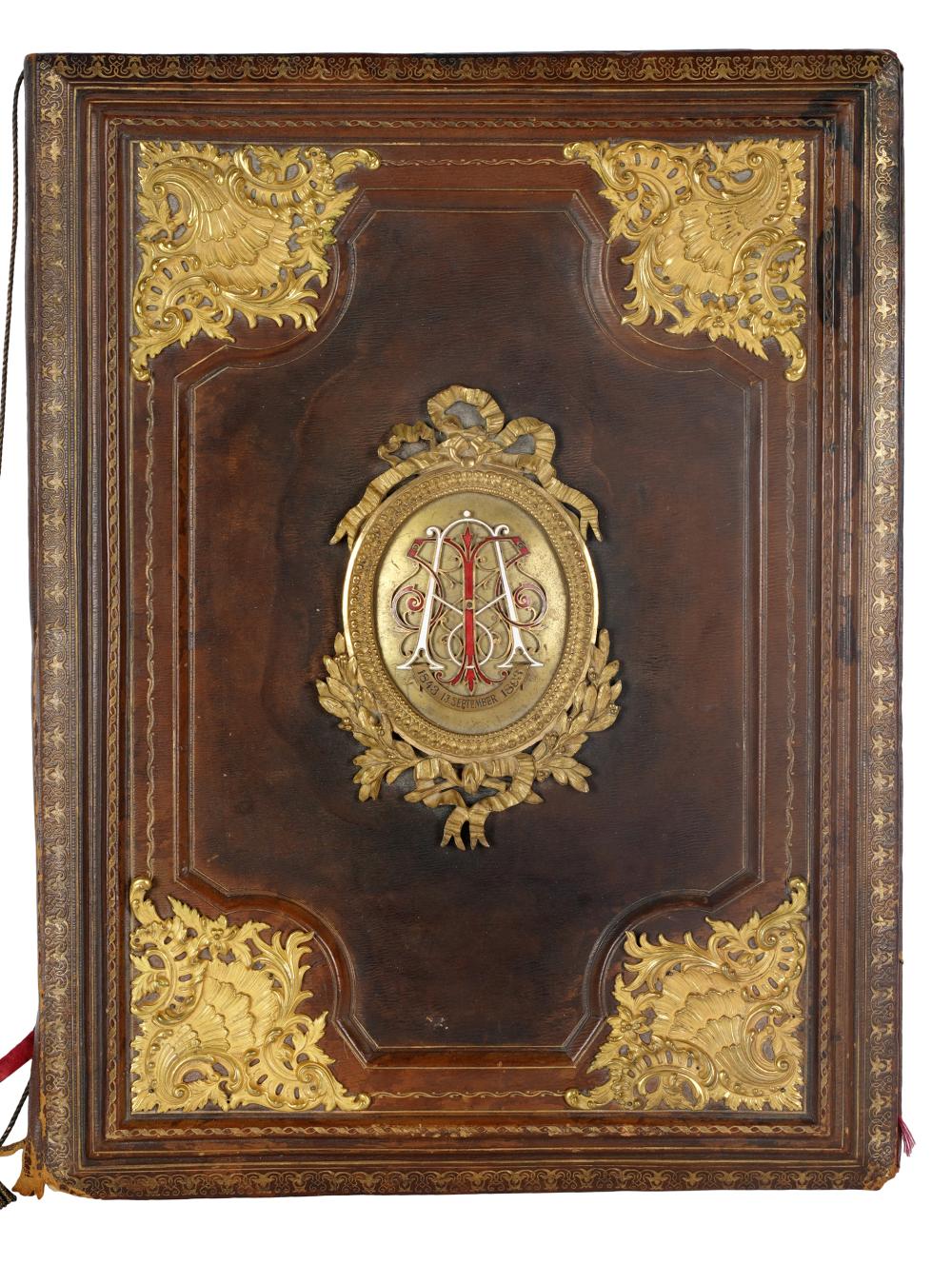 Appraisal: GILT METAL-MOUNTED LEATHER FOLDERthe front board centered by a plaque