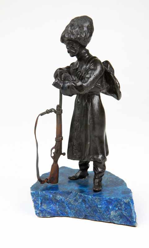 Appraisal: A Continental patinated bronze figure of a Cossack soldier Probably