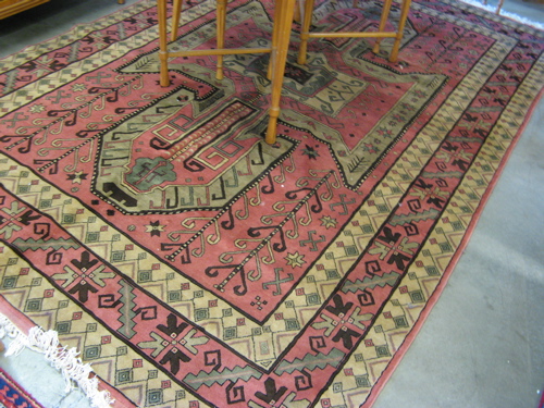 Appraisal: PAKISTANI-KAZAK CARPET geometric medallion and surrounding curvilinear decoration on rose