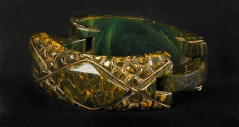 Appraisal: Bakelite Carved Bracelet with Brass Applique Clasp Description Green Condition