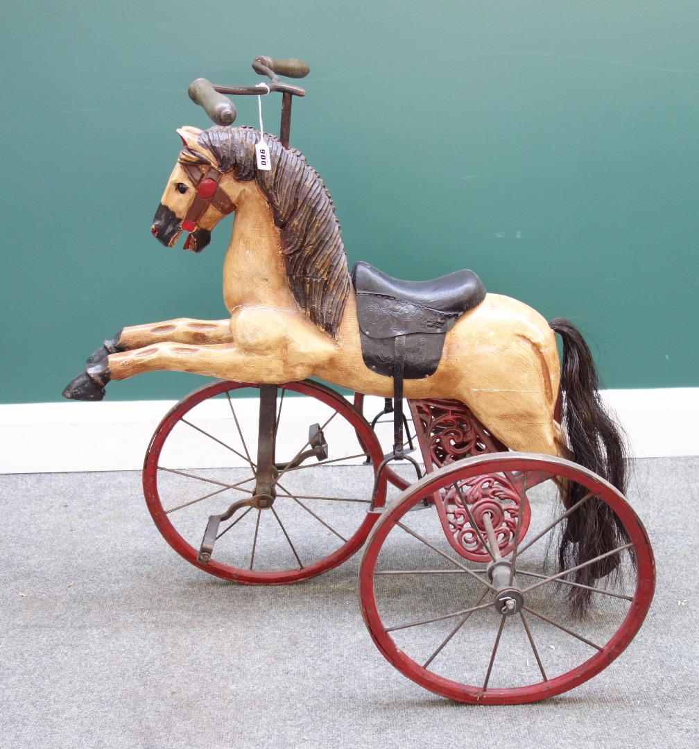 Appraisal: A reproduction horse tricycle velocipede of polychrome painted carved wood