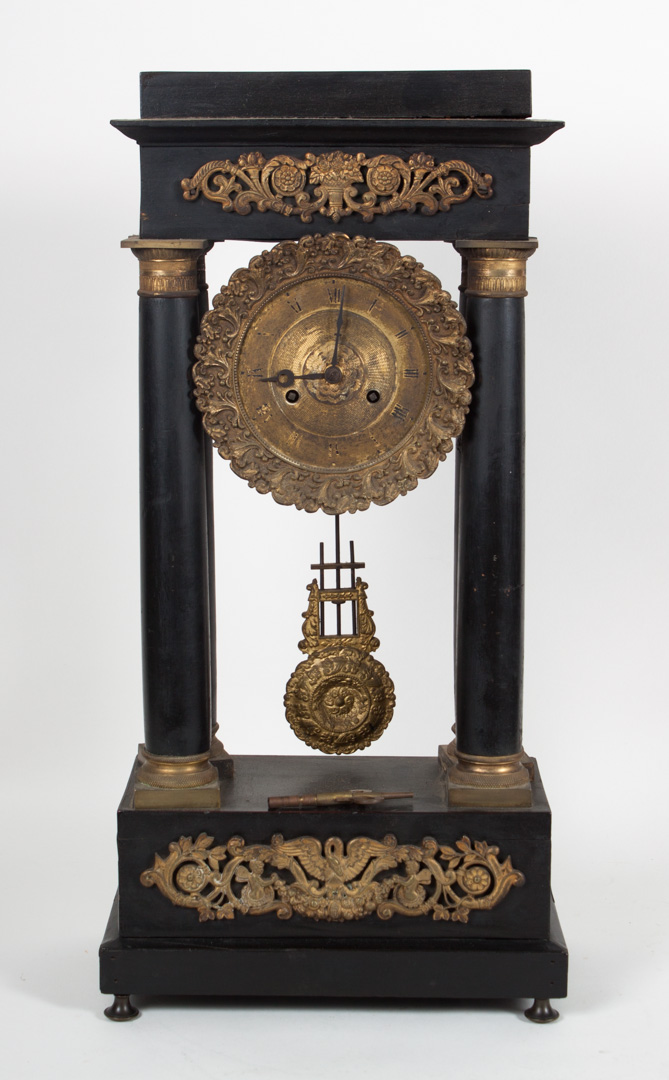 Appraisal: French Empire ebonized wood portico clock circa temple-form top with