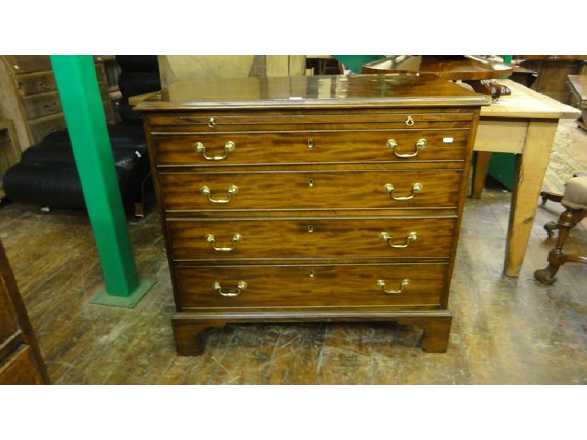 Appraisal: A George III mahogany chest of four long graduated drawers