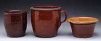 Appraisal: THREE PIECES OF REDWARE Ovoid - h handled stew pot