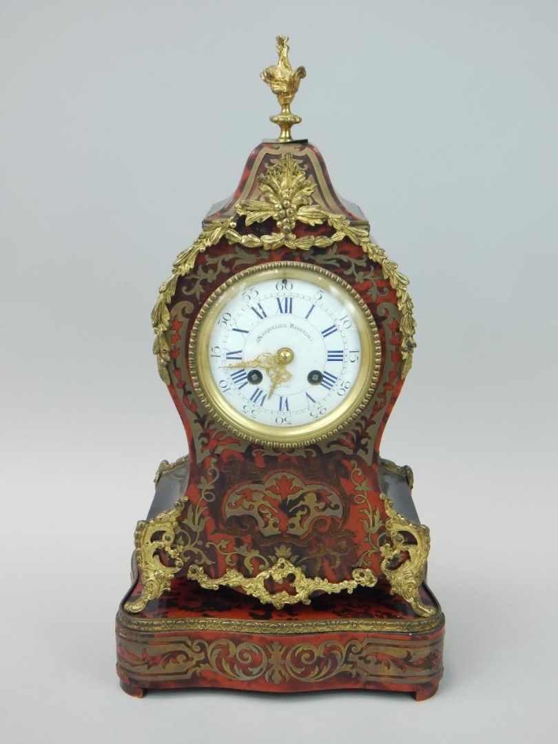 Appraisal: A thC French red tortoiseshell and brass boulle mantel clock