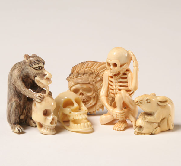 Appraisal: Japanese carved ivory netsukes skulls and skeleton Some ivory Tallest