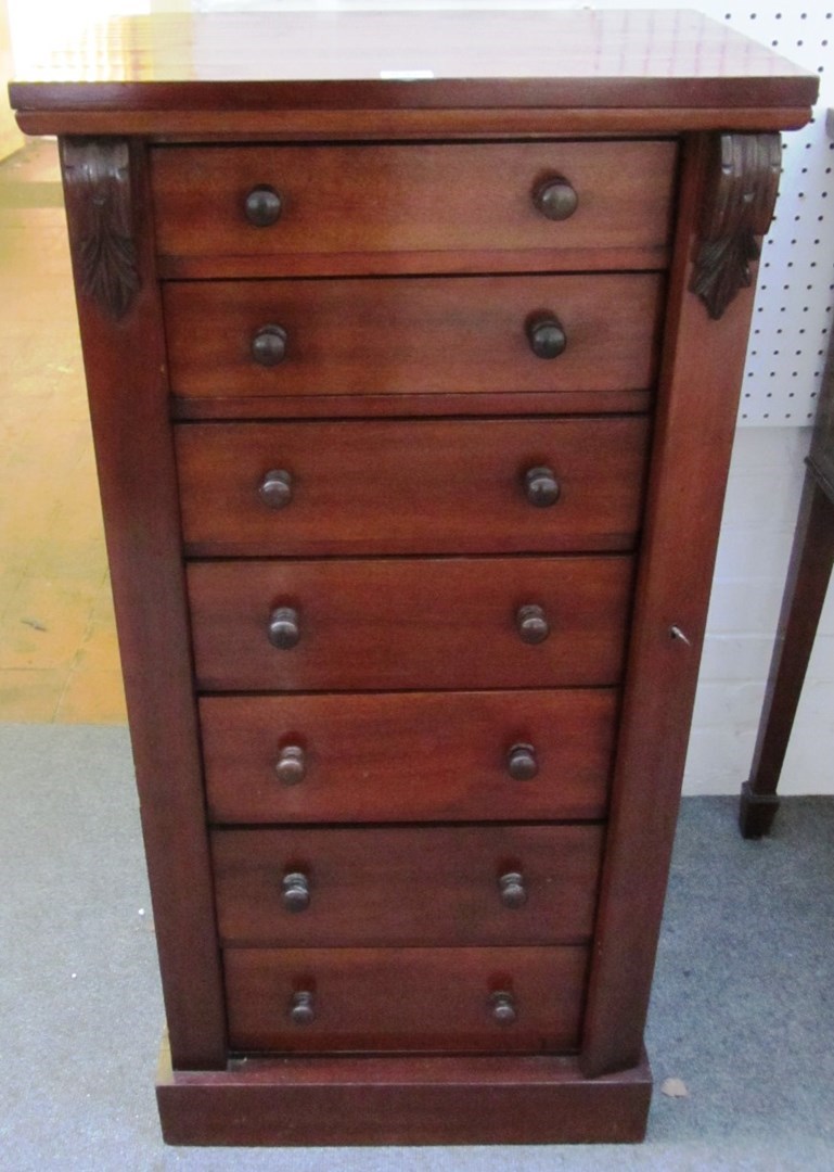 Appraisal: A Victorian mahogany Wellington chest the side locking bar enclosing