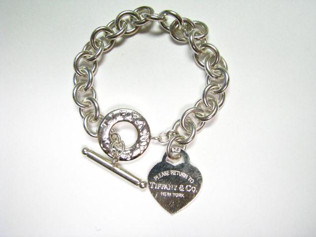 Appraisal: Tiffany sterling silver toggle bracelet with sterling heart charm inscribed