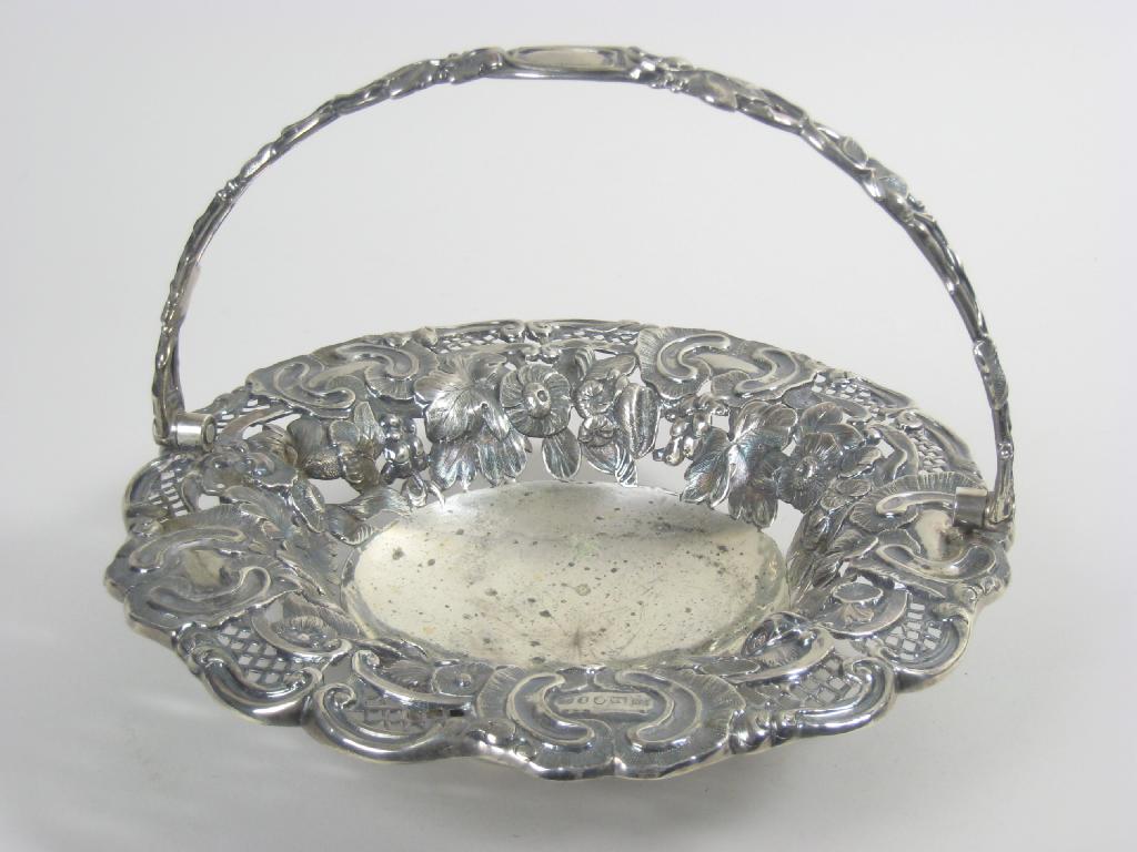 Appraisal: A Victorian floral embossed Cake Basket with swing handle Sheffield