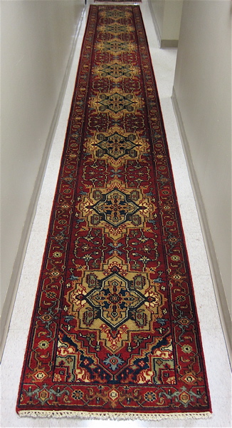 Appraisal: HAND KNOTTED ORIENTAL LONG RUG Indo-Persian the red field featuring