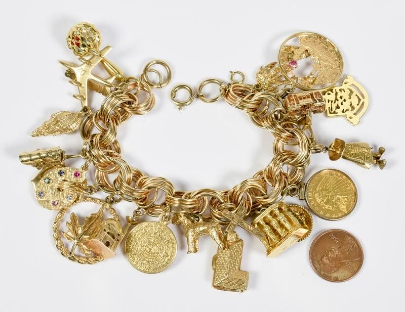 Appraisal: Charm Bracelet gold charms Gold charm link bracelet with charms