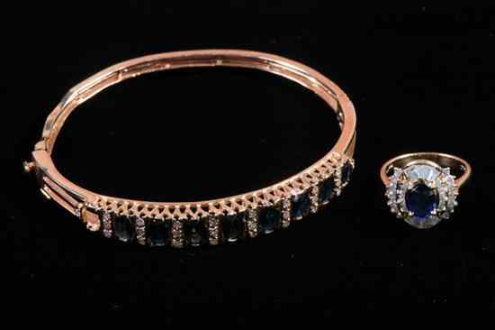 Appraisal: K YELLOW GOLD SAPPHIRE AND DIAMOND OVAL BANGLE BRACELET WITH