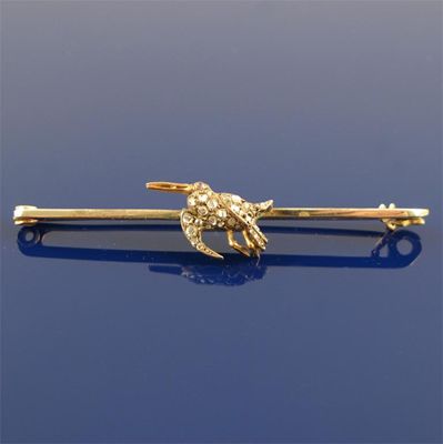 Appraisal: A gold bar brooch mounted with a diamond set woodcock