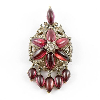 Appraisal: A Victorian diamond and cabochon garnet set circular pendant With