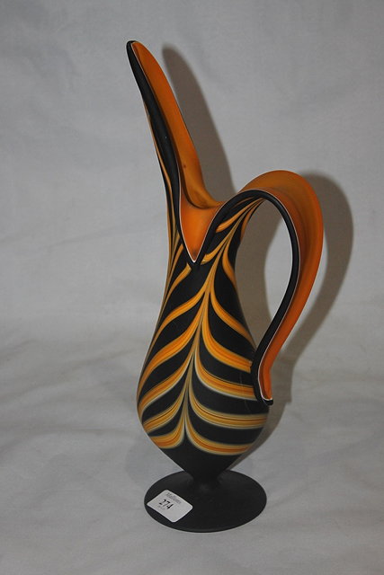 Appraisal: A FERRI STYLISED GLASS JUG of black ground with orange