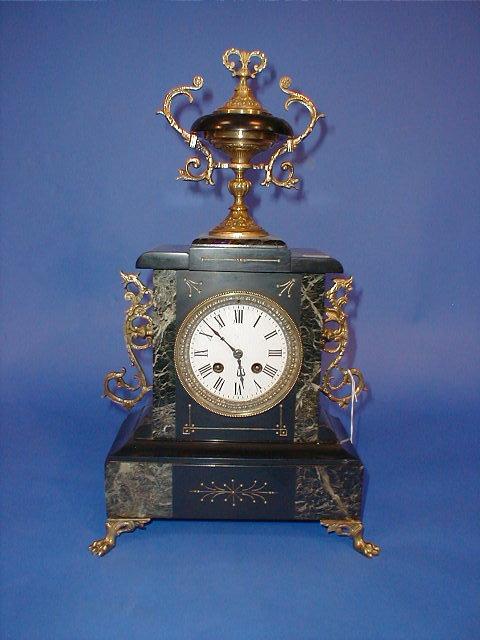 Appraisal: A Victorian style polished slate and marble mantel clock with